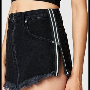 Black distressed jean mini skirt. Size 26.  Black and white stripes on sides.